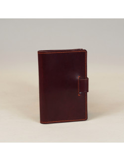 Libreta A6 en color burdeos cosida en naranja
